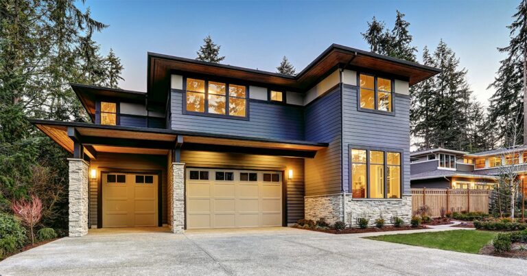 modern blue gray house with lights on GettyImages 640183848 1200w 628h 0