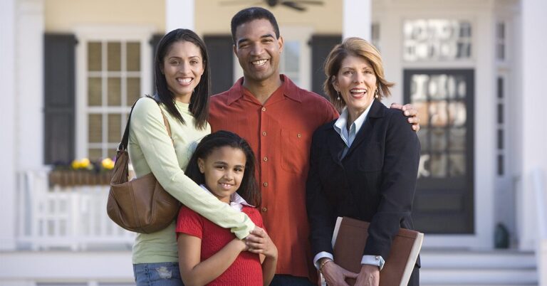 family with agent in front of house GettyImages 86807732 1200w 628h